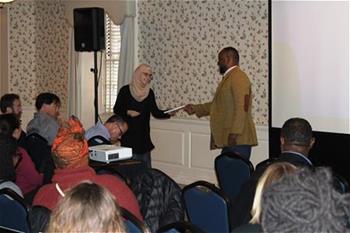 Dr. Muhammad Khalifa gives away a free copy of his book at Dean's Diversity Lecture